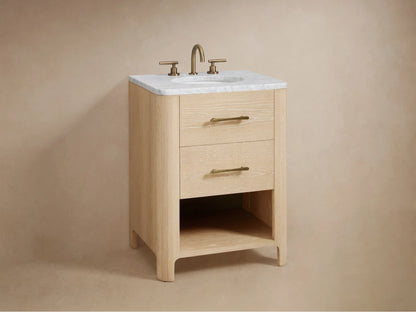 Open oak vanity drawer with soft-close glide, showing a folded towel and a wooden box inside. Antique Brass handle visible.
