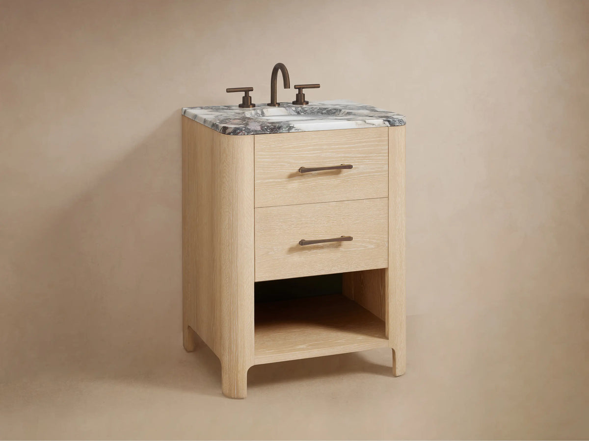 Partially open Calista Powder Vanity drawer, light oak finish, bronze handle. White towel, wooden box, and bottles inside.