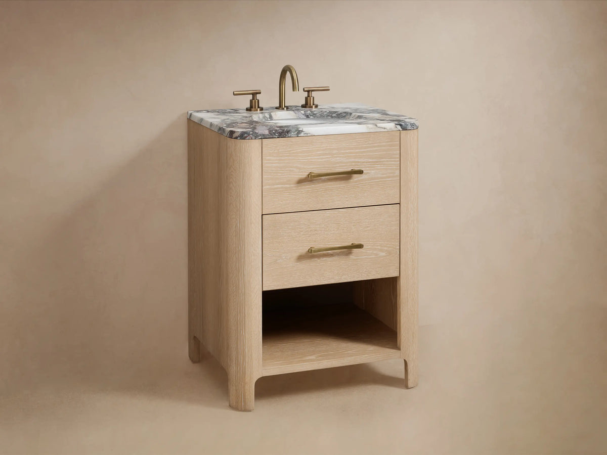 Open drawer of Calista Powder Vanity made from oak wood, revealing neatly folded white towel and small wooden box. Brass hardware visible.