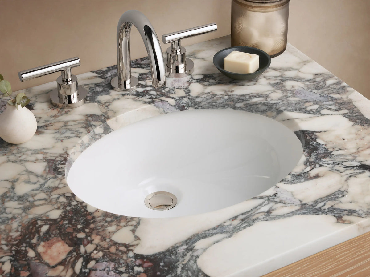 Calista Powder Vanity with light oak wood finish, two faux drawers with polished nickel handles, and a marbled stone top.