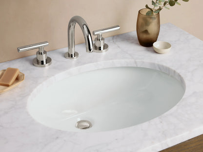 Calista Single Vanity with dark oak wood finish, two drawers with metal handles, and a white stone countertop with an oval sink.