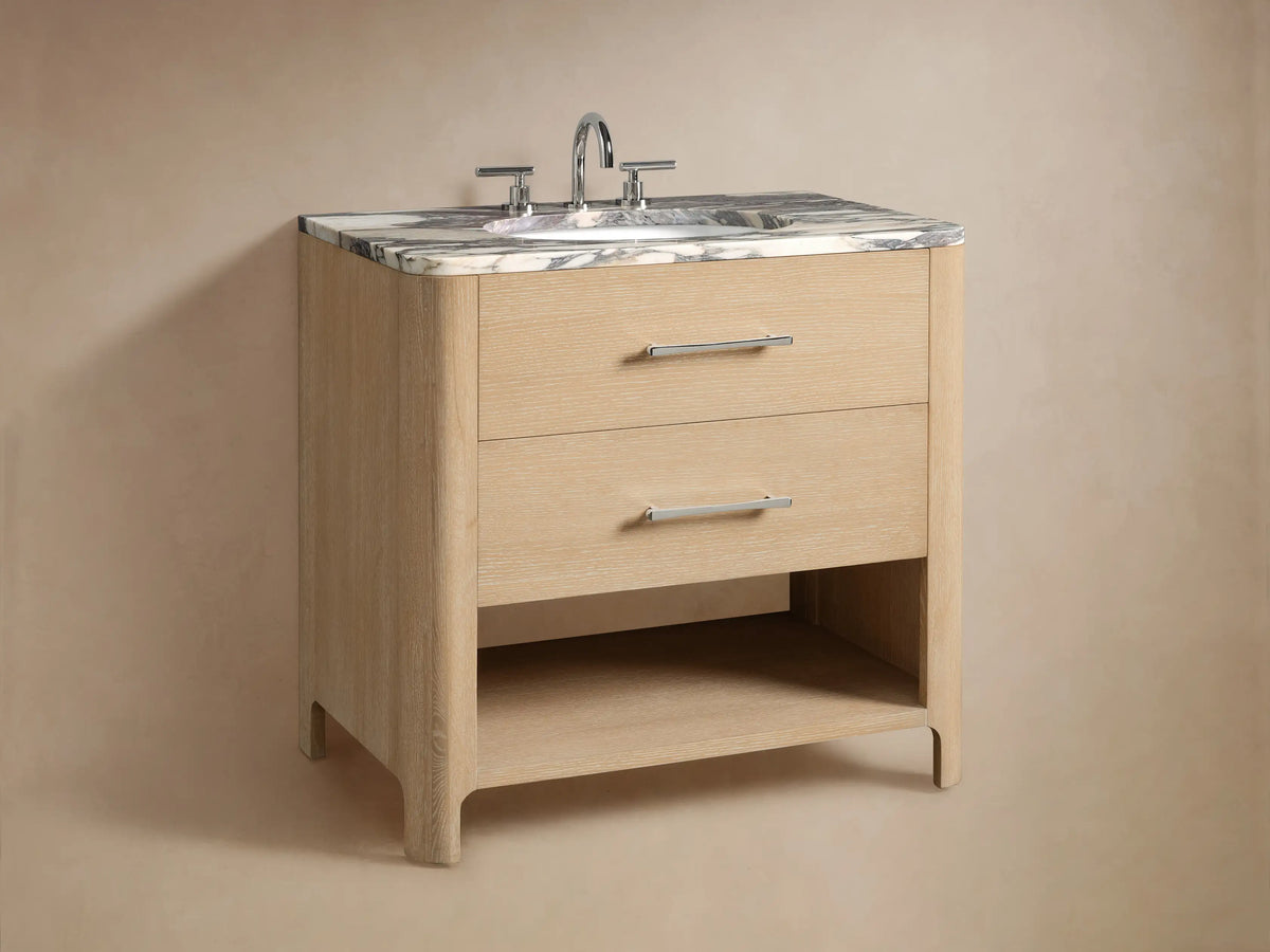 Calista Single Vanity's lower shelf with light oak finish, holding folded white towels and a natural sponge on a stone floor.