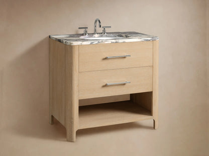 Calista Single Vanity's lower shelf with light oak finish, holding folded white towels and a natural sponge on a stone floor.