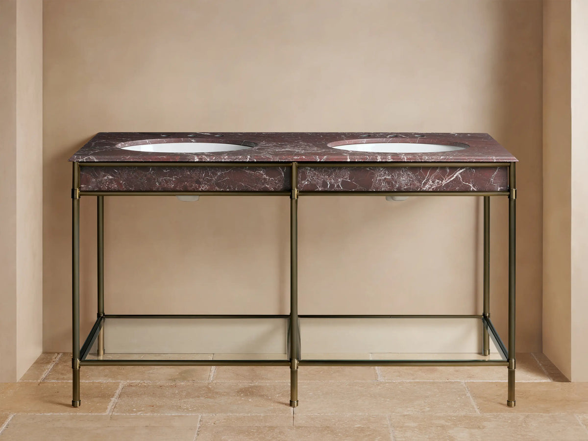Chelsea Double Washstand: Antique brass frame, Red Levanto marble top with two white sinks, brass faucets, and lower glass shelf.