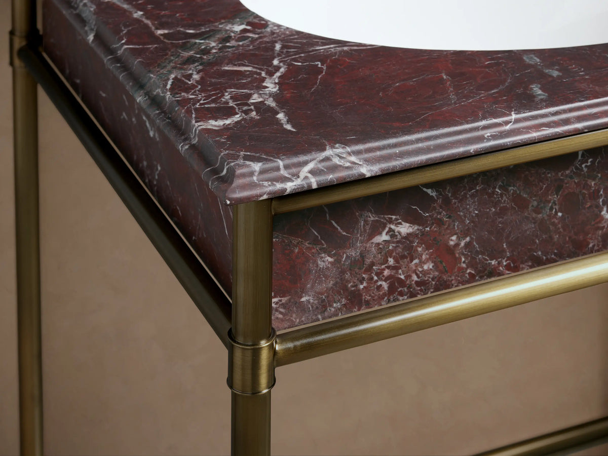 Chelsea Double Washstand: close-up of a white oval ceramic undermount sink in Red Levanto marble, with three faucet holes.
