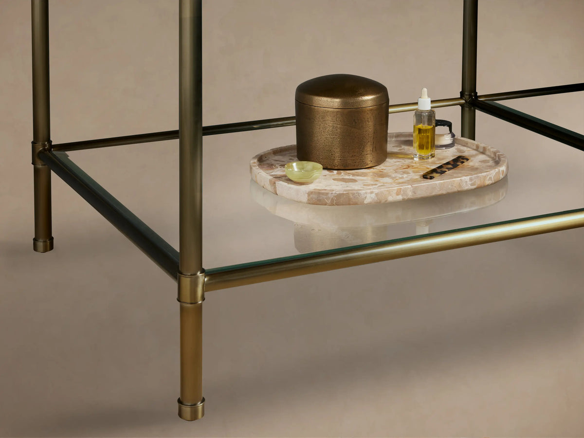 Angled close-up of Chelsea Double Washstand. Red Levanto marble top with white veining, supported by an antique brass frame.