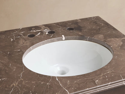 Chelsea Powder Washstand with brown marble top, white oval sink, and antique bronze widespread faucet.