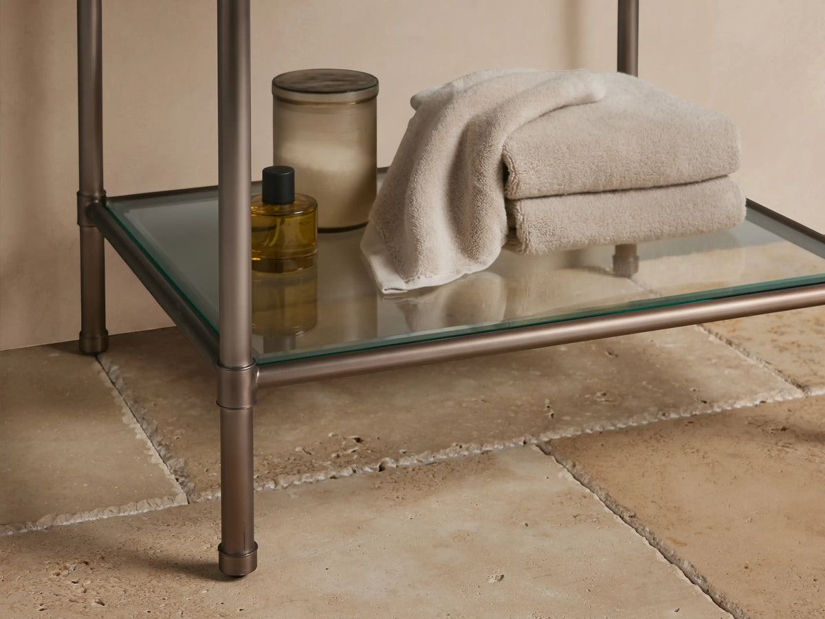Chelsea Powder Washstand: White oval undermount sink in dark brown espresso marble countertop with 3 faucet holes.