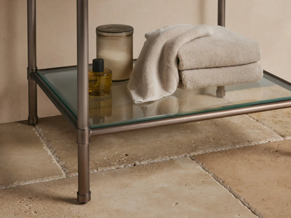 Chelsea Powder Washstand: White oval undermount sink in dark brown espresso marble countertop with 3 faucet holes.