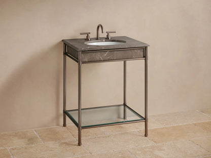 Close-up of Chelsea Powder Washstand corner; dark brown veined marble top with rounded edge on antique bronze metal frame.