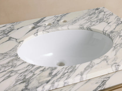 Chelsea Single Washstand close-up: white oval undermount sink in veined white marble top, antique brass faucet.