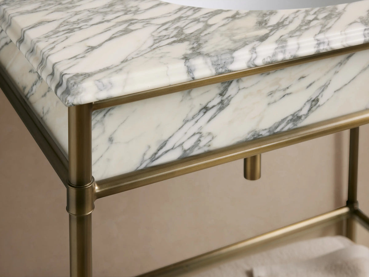 Chelsea Single Washstand: White oval ceramic undermount sink in white marble top with grey veins. Three pre-drilled faucet holes.