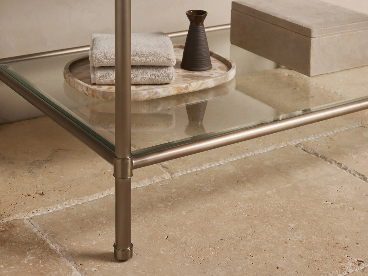 Close-up of Chelsea Single Washstand: brown marble top with white veins, rounded edge, over an antique bronze metal frame.