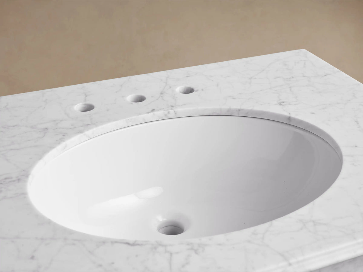 Chelsea Single Washstand: white oval undermount sink, white veined marble top, bronze widespread faucet, and matching drain.