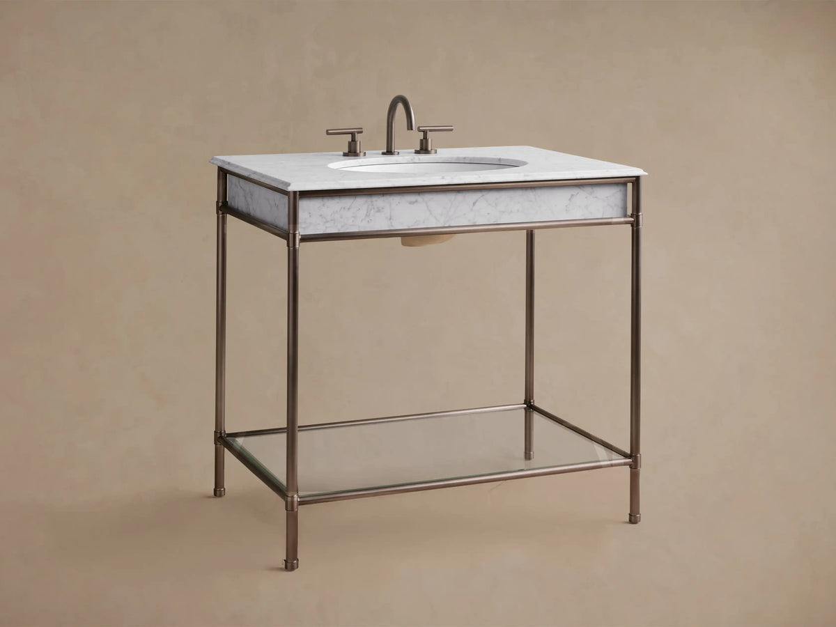 Chelsea Single Washstand: close-up of white marble top with grey veins, dark bronze metal frame & leg, and white sink.