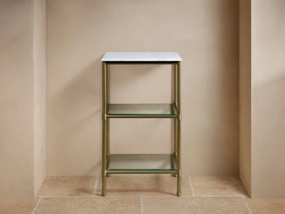 Chelsea Short Etagere with a polished nickel frame and glass shelves, holding folded beige towels.