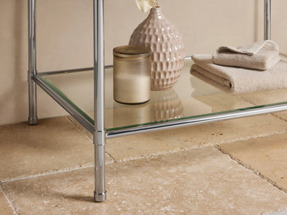 Close-up of Chelsea Single Washstand: white Carrara marble top with grey veins, polished nickel frame, partial white sink.