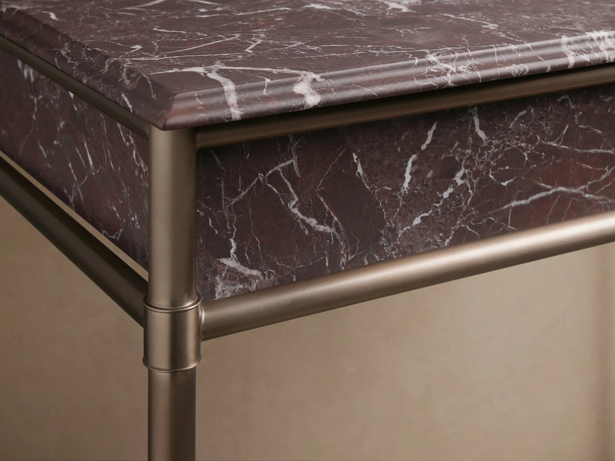 Close-up of Chelsea Single Washstand, featuring a brown marble top with white veining and a white oval undermount sink.