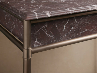 Close-up of Chelsea Single Washstand, featuring a brown marble top with white veining and a white oval undermount sink.