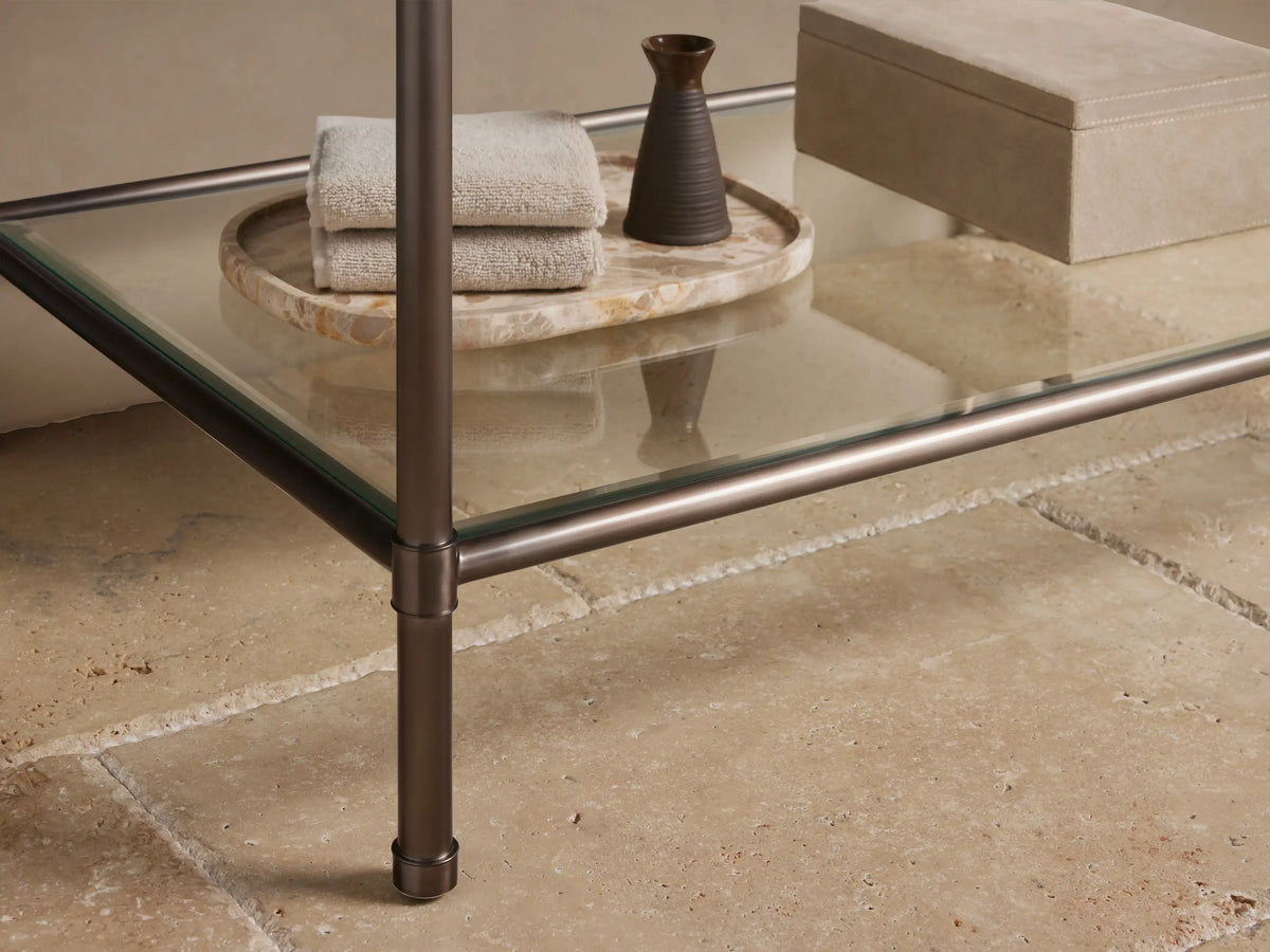 Close-up of Chelsea Single Washstand corner. Dark reddish-brown marble top with white veining on an antique bronze frame.