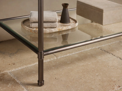 Close-up of Chelsea Single Washstand corner. Dark reddish-brown marble top with white veining on an antique bronze frame.