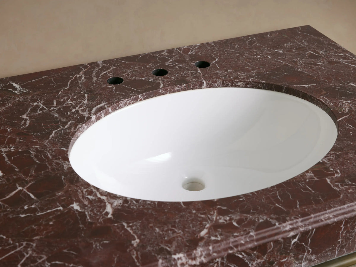 Chelsea Single Washstand: Red Levanto marble top, white oval sink with brass drain, antique brass widespread faucet & handles.