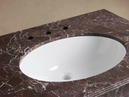 Close-up of Chelsea Single Washstand with a white oval undermount sink, dark Red Levanto marble top, and polished nickel faucet.
