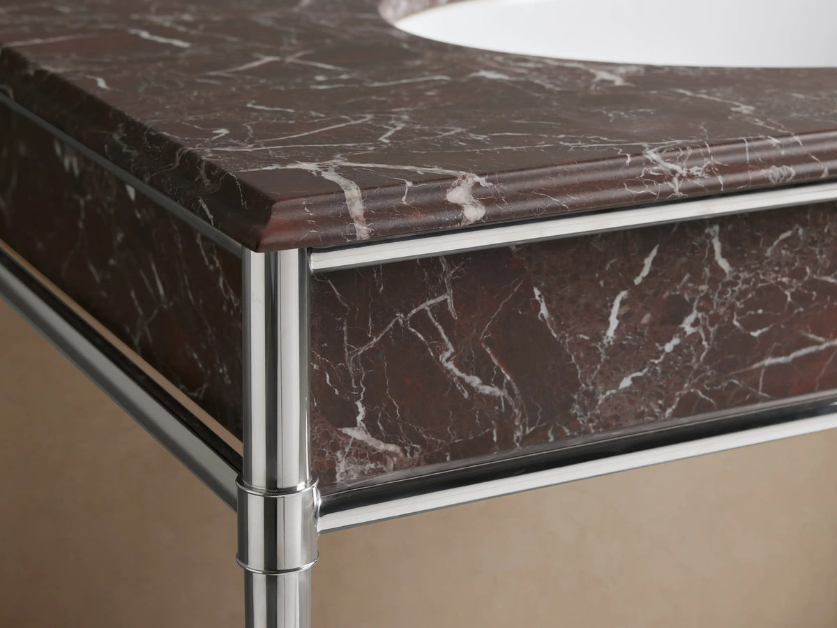 Close-up of Chelsea Single Washstand with Red Levanto marble countertop, white oval undermount sink, and three faucet holes.