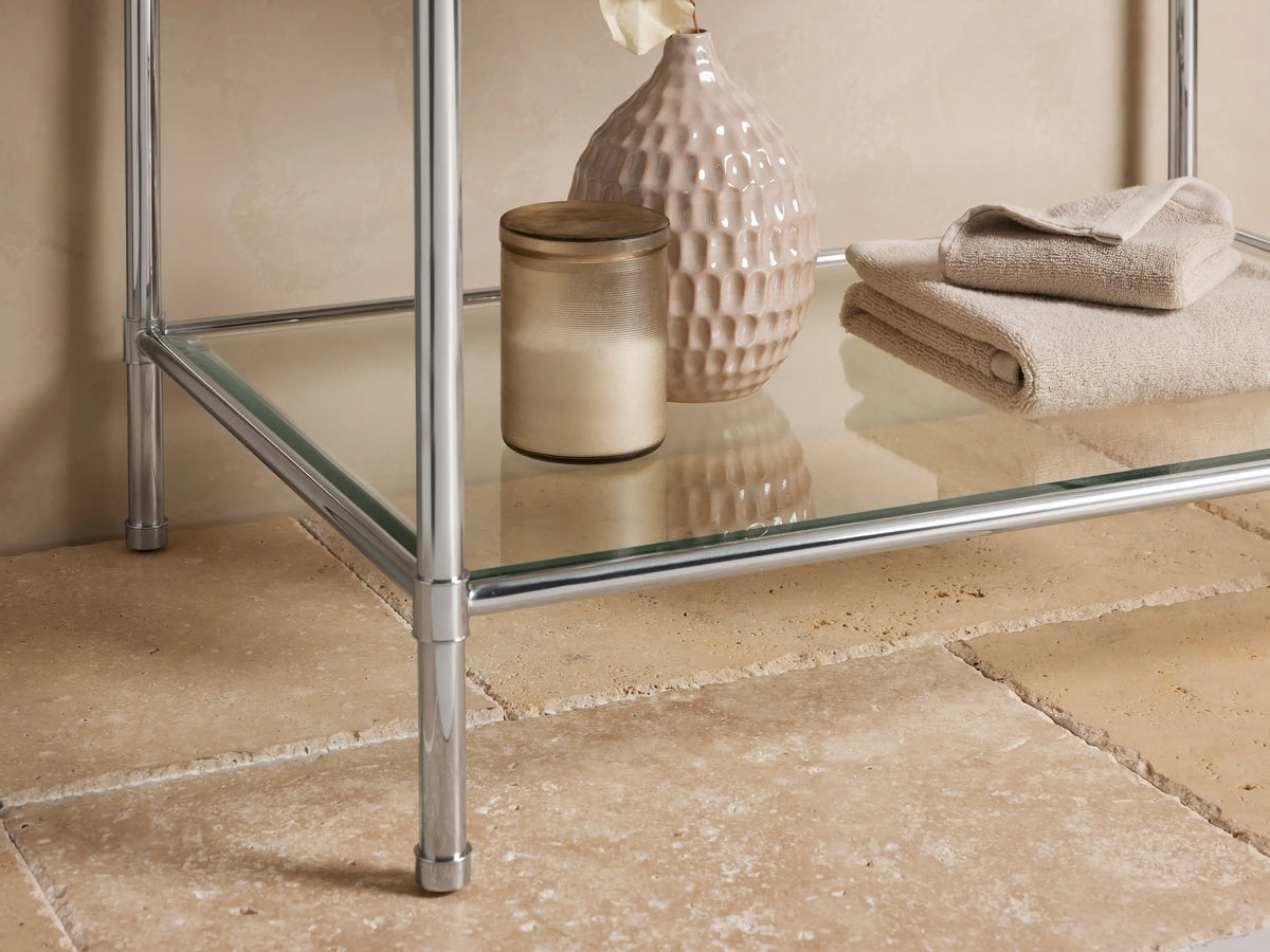 Close-up of Chelsea Single Washstand with dark brown, white-veined marble top, polished nickel frame, and white ceramic sink edge.