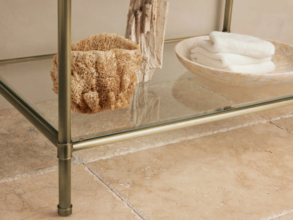 Chelsea Single Washstand: white oval undermount sink, dark gray marble countertop, antique brass widespread faucet.