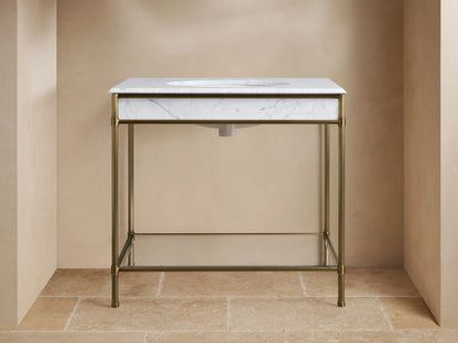 Chelsea Single Washstand: white veined marble top with undermount sink, antique brass frame, and glass shelf.