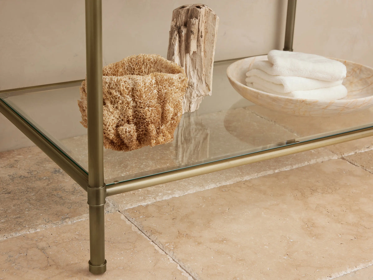 Chelsea Single Washstand: White oval undermount sink, veined Carrara marble top, antique brass faucet.