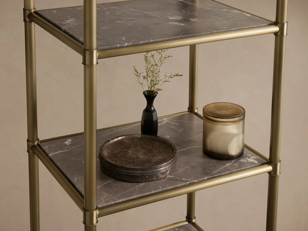 Chelsea Tall Etagere with antique brass finish, featuring five brown espresso marble stone shelves, against a neutral wall.