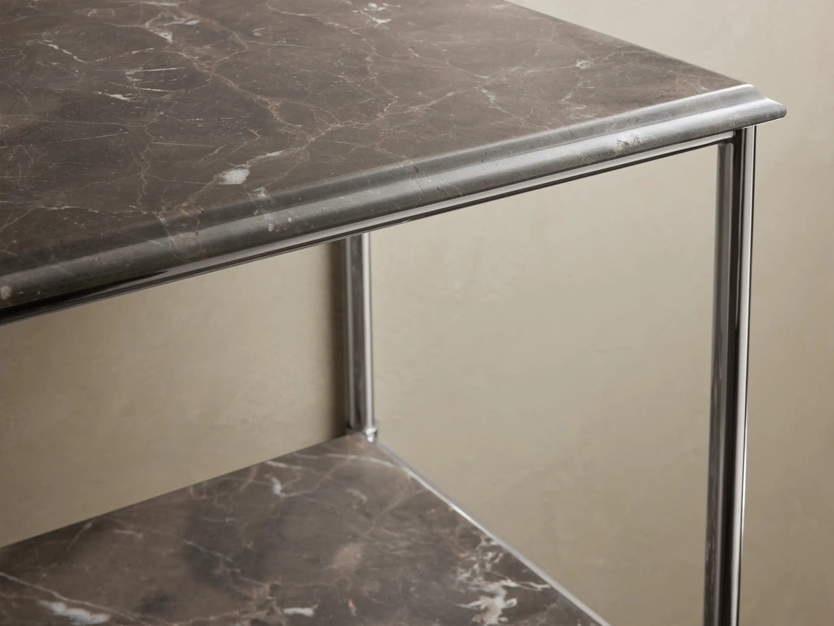 Chelsea Tall Etagere with polished nickel frame, Carrara marble shelves; top shelf holds a ceramic bowl, lower shelf has folded towels.