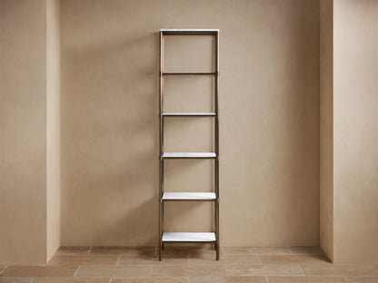 Chelsea Tall Etagere: Antique brass frame, 5 white marble shelves, styled with light towels, black and white decor on a tan wall.