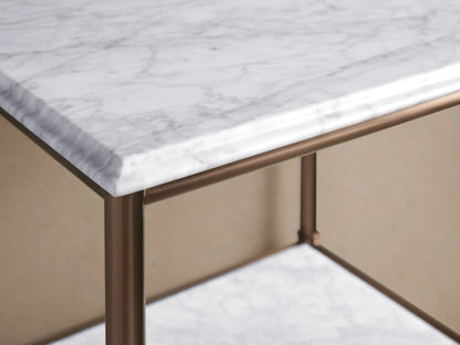Close-up of Chelsea Tall Etagere with Antique Brass frame, white marble shelves, holding beige towels and a decorative bowl.