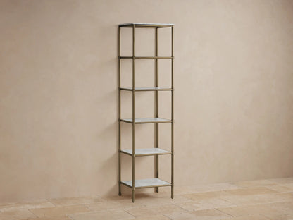 Chelsea Tall Etagere with five shelves, steel frame in antique brass finish, marble tops, styled with decorative items.