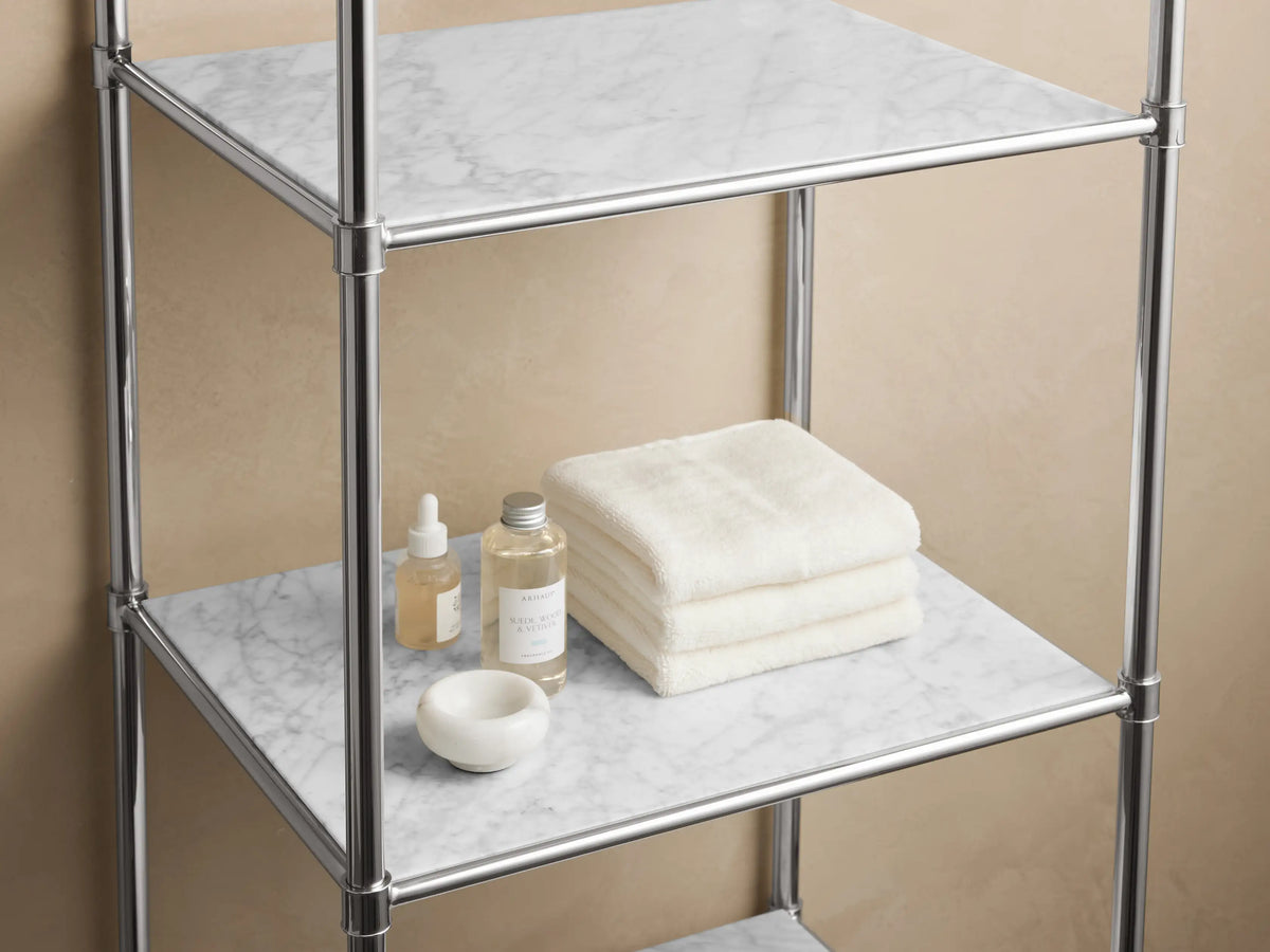 Chelsea Tall Etagere in polished nickel finish with six shelves, featuring a stone top against a neutral wall.