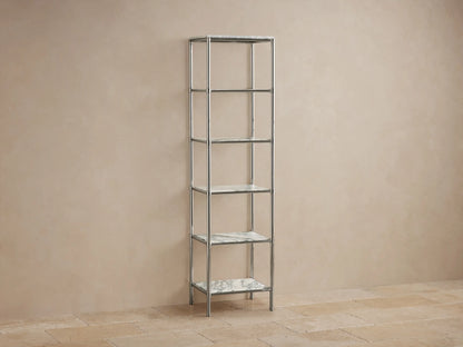 Chelsea Tall Etagere, polished nickel frame, 5 veined marble shelves, displaying towels, bottles, vases in a beige room.