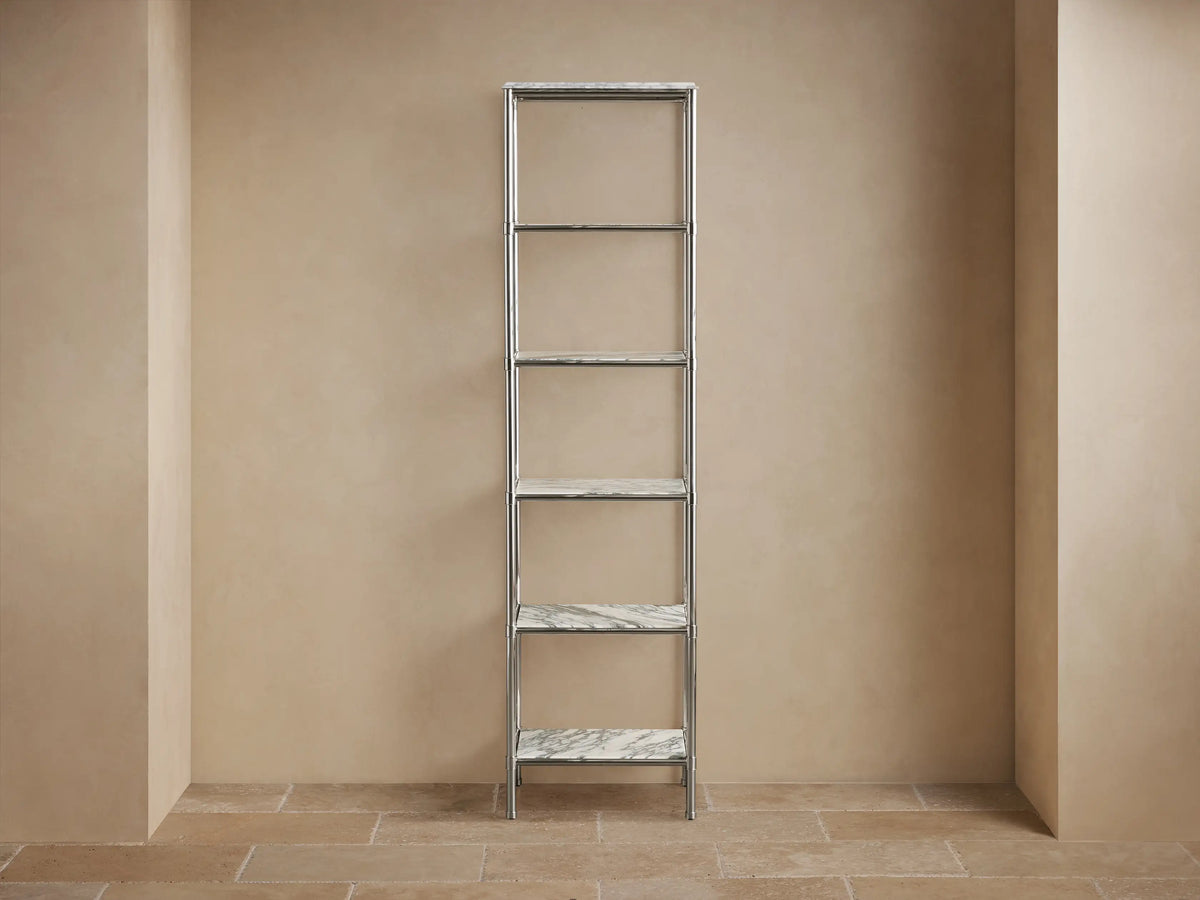 Chelsea Tall Etagere close-up: white Carrara marble top with gray veins, decorative edge, and polished nickel frame.