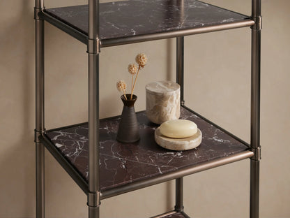 Chelsea Tall Etagere with an antique bronze metal frame and 5 dark red marble shelves, standing against a beige wall.