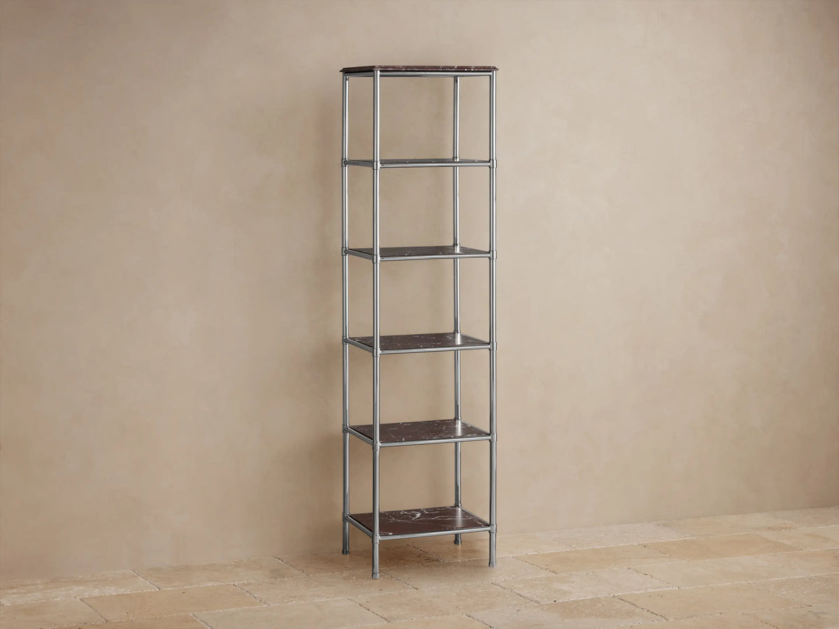 Chelsea Tall Etagere: Polished nickel frame with five dark brown marble shelves, styled with decor against a beige wall.
