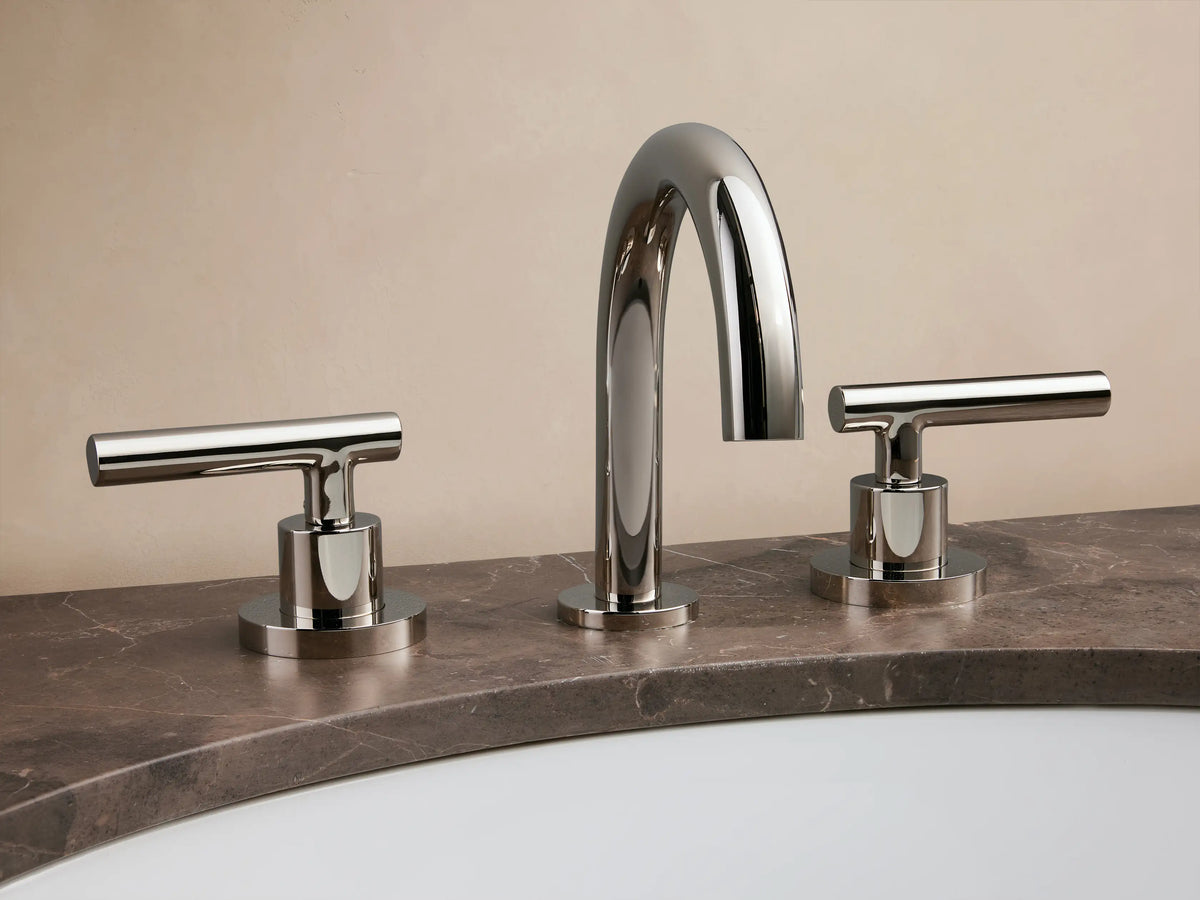 Crewe Smooth Faucet in polished nickel finish with curved spout and dual lever handles on a beige countertop.