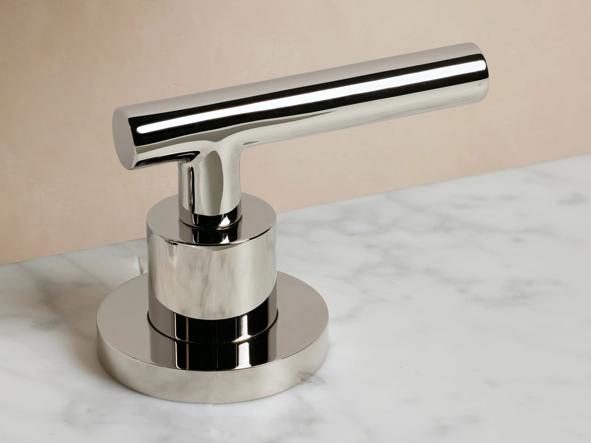 Crewe Smooth Faucet in polished nickel finish. Features a curved spout and two cylindrical handles, mounted on a white countertop.