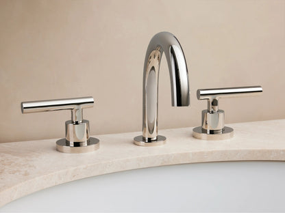 Crewe Smooth Faucet with polished nickel finish on marble counter, features sleek, curved spout and two cylindrical handles.