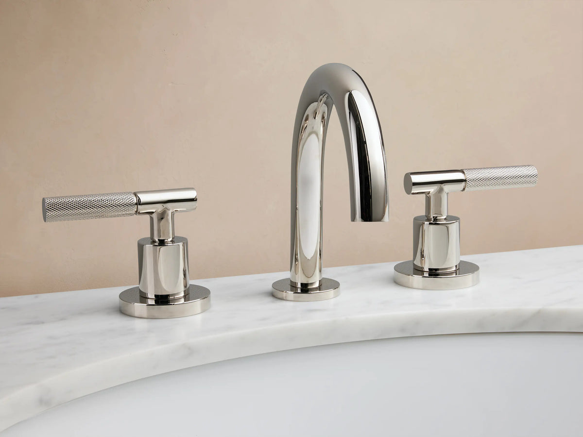 Crewe Knurled Faucet in polished nickel, featuring a curved spout and two cylindrical handles on a marble countertop.