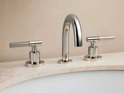 Crewe Knurled Faucet in polished nickel with curved spout and two textured handles on marble countertop, set against a beige background.