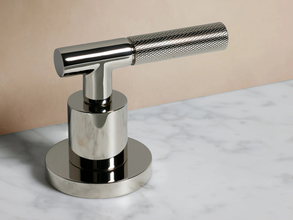 Crewe Knurled Faucet in polished nickel finish, featuring two textured handles and an arched spout on a marble countertop.
