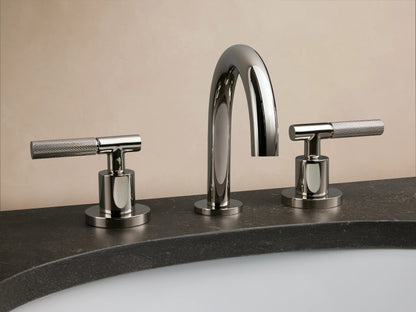 Crewe Knurled Faucet in polished nickel on a white marble countertop with two knurled handles and an oval sink.