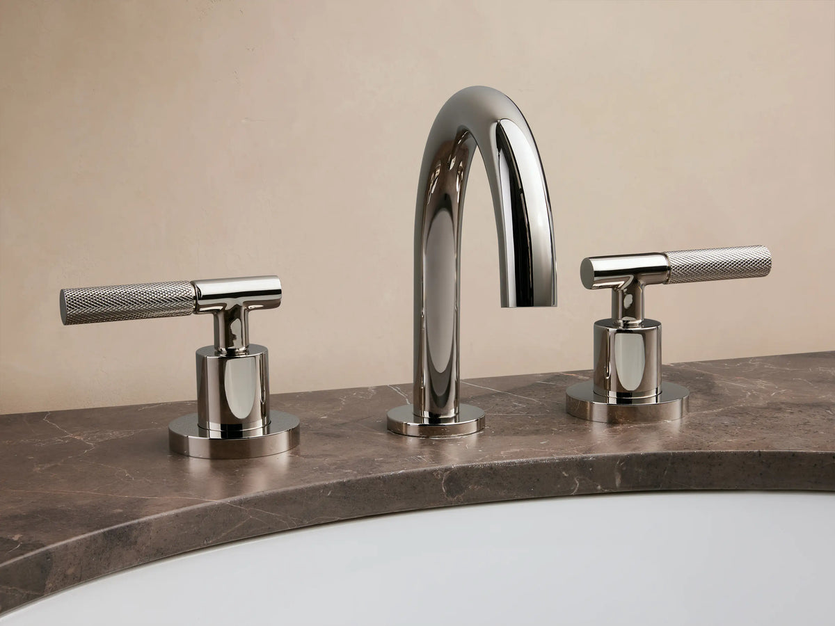 Crewe Knurled Faucet in polished nickel finish; features curved spout and two textured handles on a marble countertop.